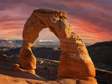 Delicate Arch In Arches National Park With Clouds And Moon