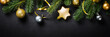Black christmas background with fir tree and golden decorations. Flat lay image with copy space.