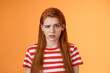 Close-up stupified puzzled redhead perplexed woman, open mouth raise eyebrow full disbelief, confused frowning, cannot understand person saying nonsense, stand questioned orange background