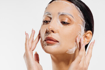 Beautiful young shirtless woman posing with cosmetic facial mask, Woman with moisturizing sheet mask on her face