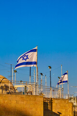 Wall Mural - the flags of israel near the walls of the old city of Jerusalem, near western wall, sunny day. Israel