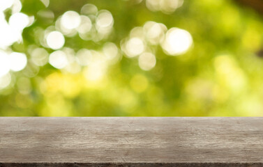 Wall Mural - Rustic wooden table on outdoor forest blurred background.