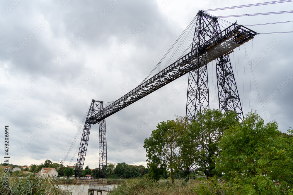 Transporter Bridge over the Charente river under a cloudy sky. National monument. Rochefort sur mer. France