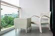 Empty white rattan chair on balcony on high rise building
