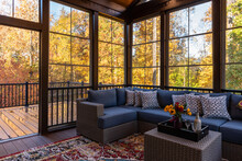 Cozy Screened Porch In Early Morning, Rain Drops On Window And Autumn Leaves And Woods In The Background.