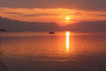 Scenic Sunset And A Lonely Sailboat At The Coast Of Trogir