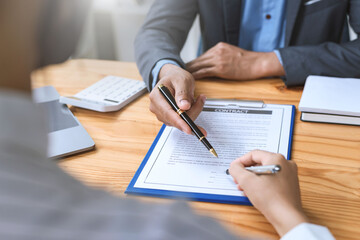 Wall Mural - Business people discussing contract in office. Contracting and signing business investment.