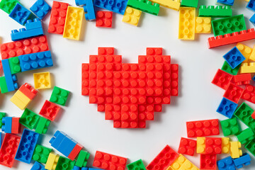 Shape of heart brick kid toy on white background.