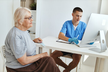 Wall Mural - an elderly woman at a doctor's appointment diagnostics