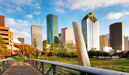 Wall Mural - ooden bridge in Buffalo Bayou Park, with a beautiful view of downtown Houston (skyline / skyscrapers) in background on a summer day - Houston, Texas, USA