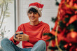 © carballo - teenager at home with christmas tree and cup