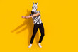Full length photo of freak bizarre guy in zebra costume dance rhythm festival isolated over bright yellow color background