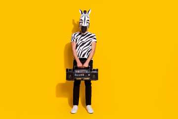 Sticker - Full length photo of freak crazy unusual guy in zebra costume hold boom box isolated over yellow shine color background