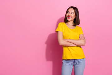 Poster - Photo of dreamy confident young woman wear yellow outfit looking empty space arms crossed smiling isolated pink color background