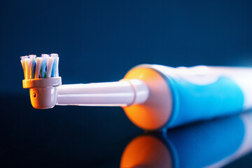 Wall Mural - close-up electric toothbrush on blue background