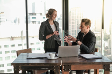 Two businessman and businesswoman couple meeting in co working space at sky lounge