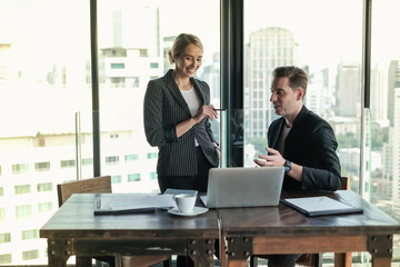 Two businessman and businesswoman couple meeting in co working space at sky lounge