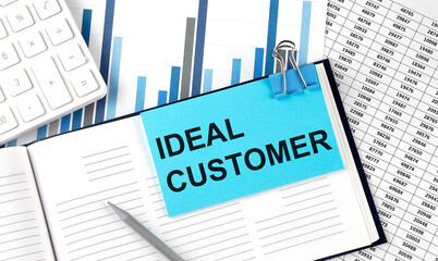 Poster - IDEAL CUSTOMER text on blue sticker on the chart background near calculator