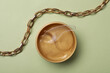 © New Africa - Under eye patches in jar with spatula and necklace on olive background, flat lay. Cosmetic product