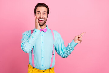 Sticker - Photo of adorable excited young guy dressed teal clothes arm cheek pointing finger empty space smiling isolated pink color background