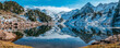 Reflection of the snowy mountains in the beautiful Baciver lake in the Pyrenees mountains of Val d'Aran (Aran Valley), Lleida, Catalonia, Spain