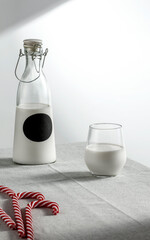 Wall Mural - A minimalist composition of Christmas milk on the table and blank 