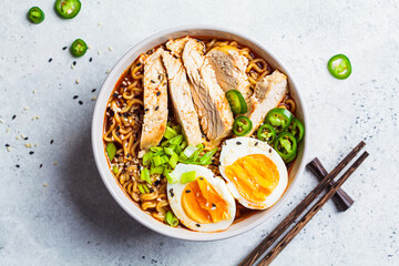 Wall Mural - Asian noodle soup ramen with chicken and egg in gray bowl. Japanese food concept.