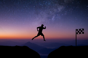 Wall Mural - Young man jumping over precipice between two mountains cross the finish line with beautiful night sky, star and Milky Way over the sky. showing determination, freedom, risk, challenge, success.