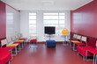 © Mint Images - Corridor and waiting areas of a modern hospital with seating Yellow bag.
