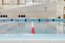 Indoor Swimming Pool, Red And White Dividers In Swim Lanes, Surface View. 