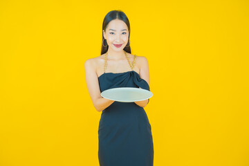 Wall Mural - Portrait beautiful young asian woman smile with empty plate dish