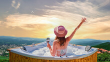 Girl Traveler With A Glass Of Wine Enjoying Relaxing Pampering Luxury Weekend In A Hot Tub With Foam At Resort Outdoors