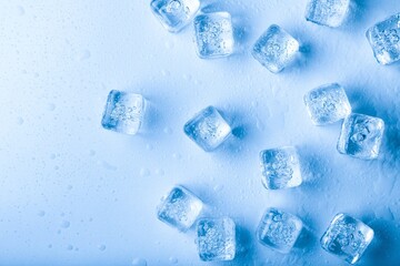 Sticker - Top view. Ice cubes with water drops scattered on a background.