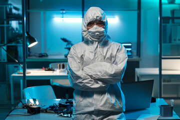 Poster - Young female in protective workwear standing against desk with laptop and hardware inside laboratory