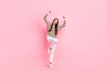 Poster - Photo of cute lucky young woman wear dotted sweater smiling walking rising fists isolated pink color background