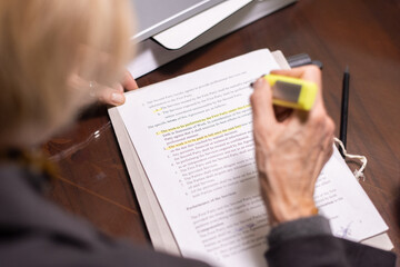 Aufkleber - Hand of mature female lawyer highlighting main points of contract while reading its terms and conditions