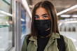© Westend61 - Woman with protective face mask at subway