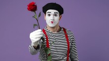 Charismatic Charming Vivid Young Mime Man With White Face Mask Wears Striped Shirt Beret Look Camera Present Give Flower Rose To You Isolated On Plain Pastel Light Violet Background Studio Portrait