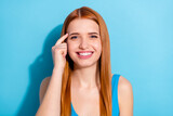 Fototapeta Na ścianę - Portrait of pretty smart cheerful red-haired girl touching temple thinking isolated over vibrant blue color background