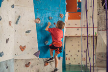 Boy At The Climbing Wall Without A Helmet, Danger At The Climbing Wall