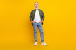 Full length body size photo of senior man smiling cheerful wearing stylish outfit isolated vibrant yellow color background