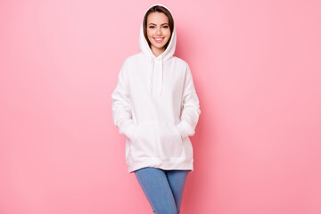 Wall Mural - Photo of pretty cute young woman dressed white sweatshirt arms pockets smiling isolated pink color background