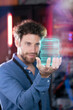 © Westend61 - Male IT professional holding hologram of database in server room