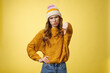 Lame dislike unfollow. Portrait disappointed displeased picky young judgemental woman show thumb-down cringing grimacing unsatisfied expressing disapproval antipathy, yellow background