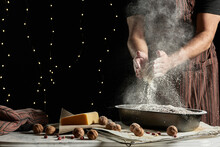 Crop Anonymous Male Baker In Apron Spilling Flour Over Baking Pan With Bread While Working At Table With Ingredients