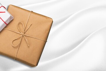 Wall Mural - Gift box wrapped in craft paper with ribbon on the background decorative box for putting present in.