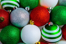 Overhead View Of Red, Green, White Shiny Glowing Christmas Balls. Xmas Glass Ball. Holiday Decoration Background