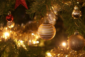 Close up of Christmas baubles, lights and decorations on a Christmas Tree