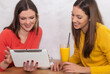 © oreans - two girls looking at tablet smiling