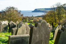 Old Gravestones On A Green Slope With Sea View In Yorkshire England